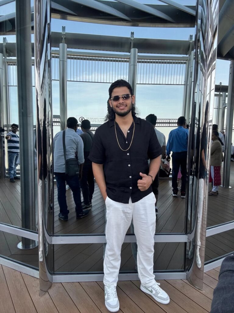 Man in black shirt and white pants in reflective room